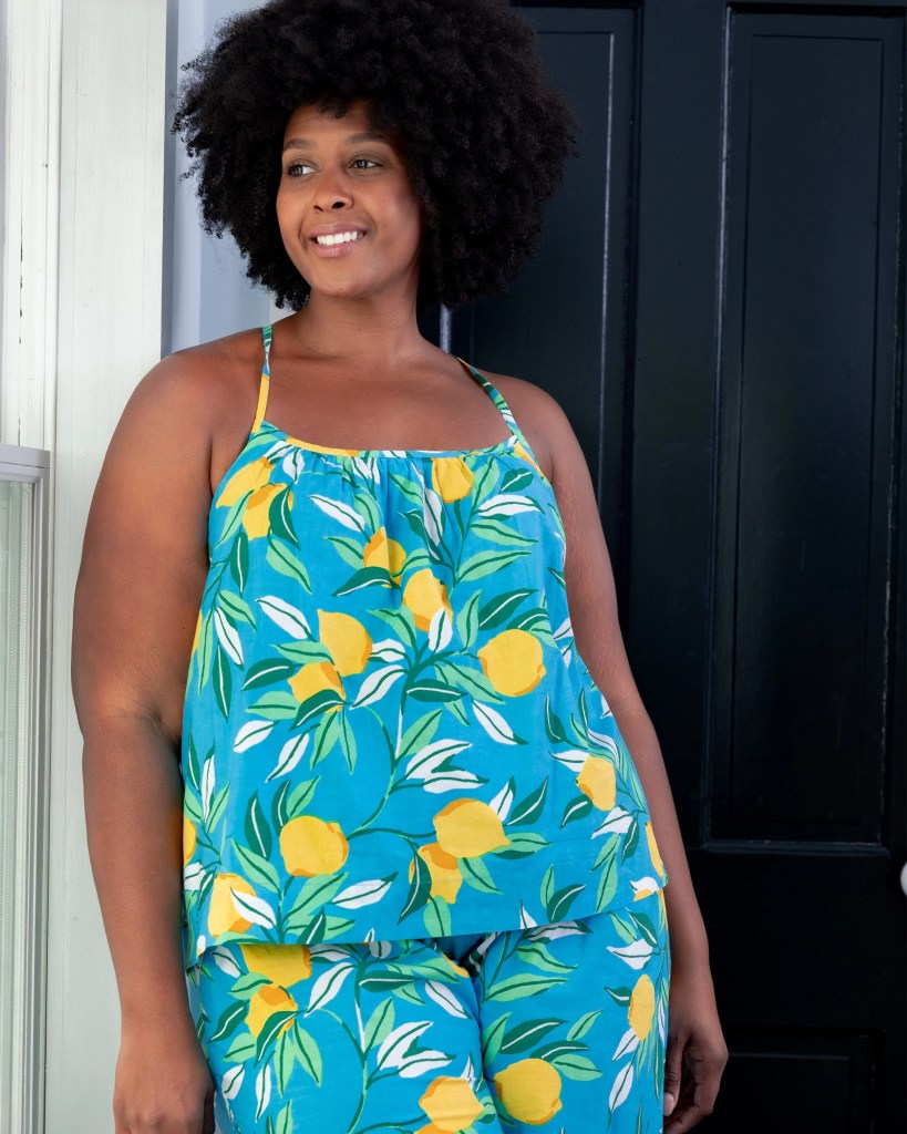 Curvy AA woman wear lemon and turquoise pajamas