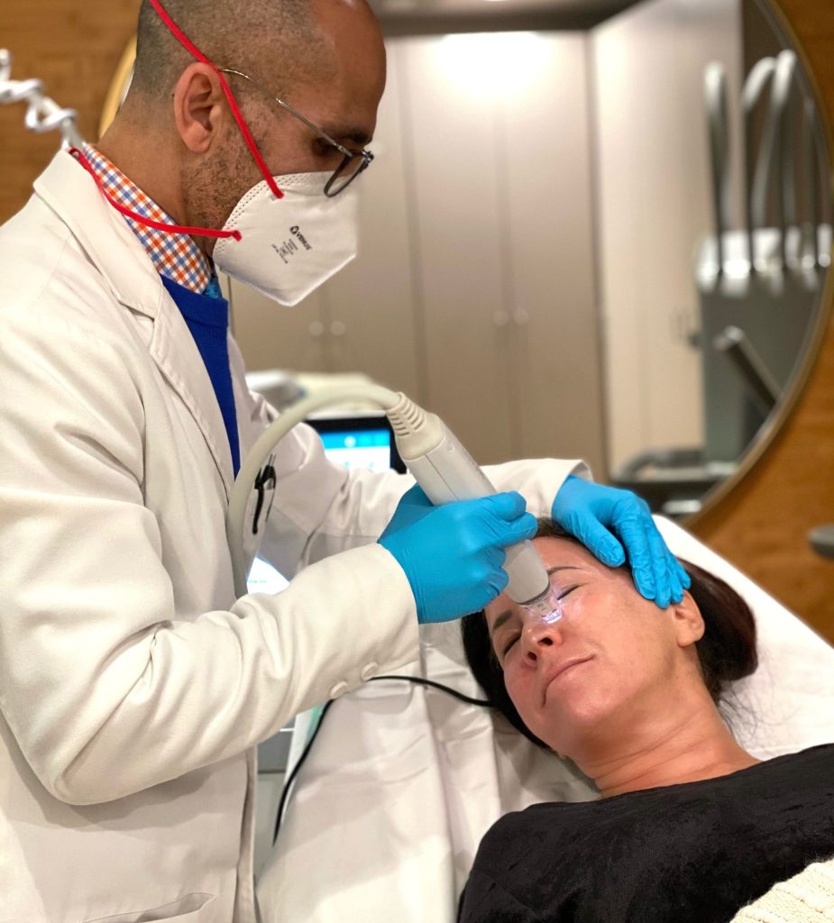 Doctor using a Potenza Microneedling device on a woman's face to revitalize the look of her skin. 