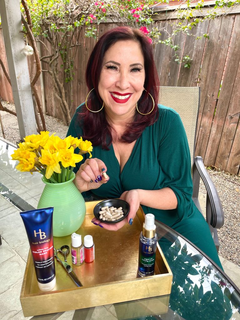 woman in green dress holding vitamins