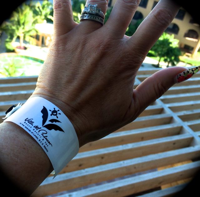 Image of a woman's wrist with a band that acts as a room key for the all-inclusive resort in Loreto, Mexico.