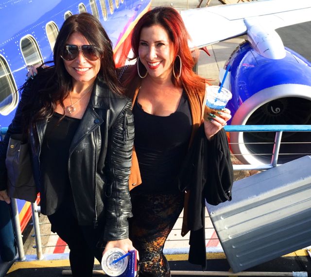 Two girls in front of an airplane.